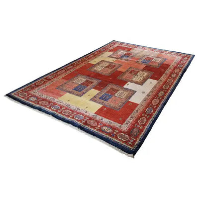 Rug with a red base, geometric squares, and a blue decorative border at the edge