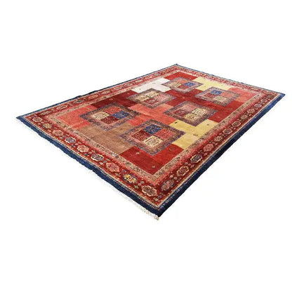 Carpet with a red central area, patchwork squares, and a blue border edge