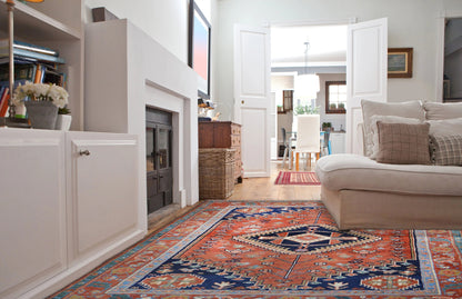 Qashqai rug 3809 with an oriental pattern, lying on the floor in the living area, red & blue