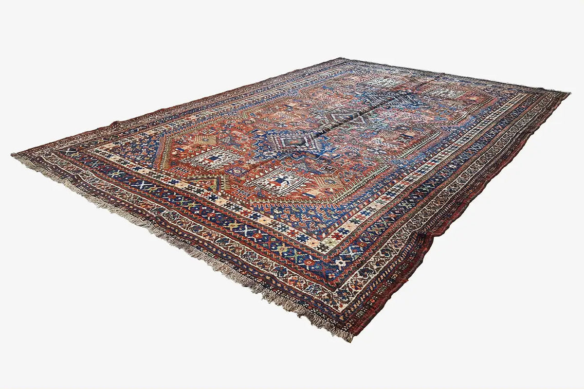 Rectangular Oriental rug with a blue-brown pattern and fringes