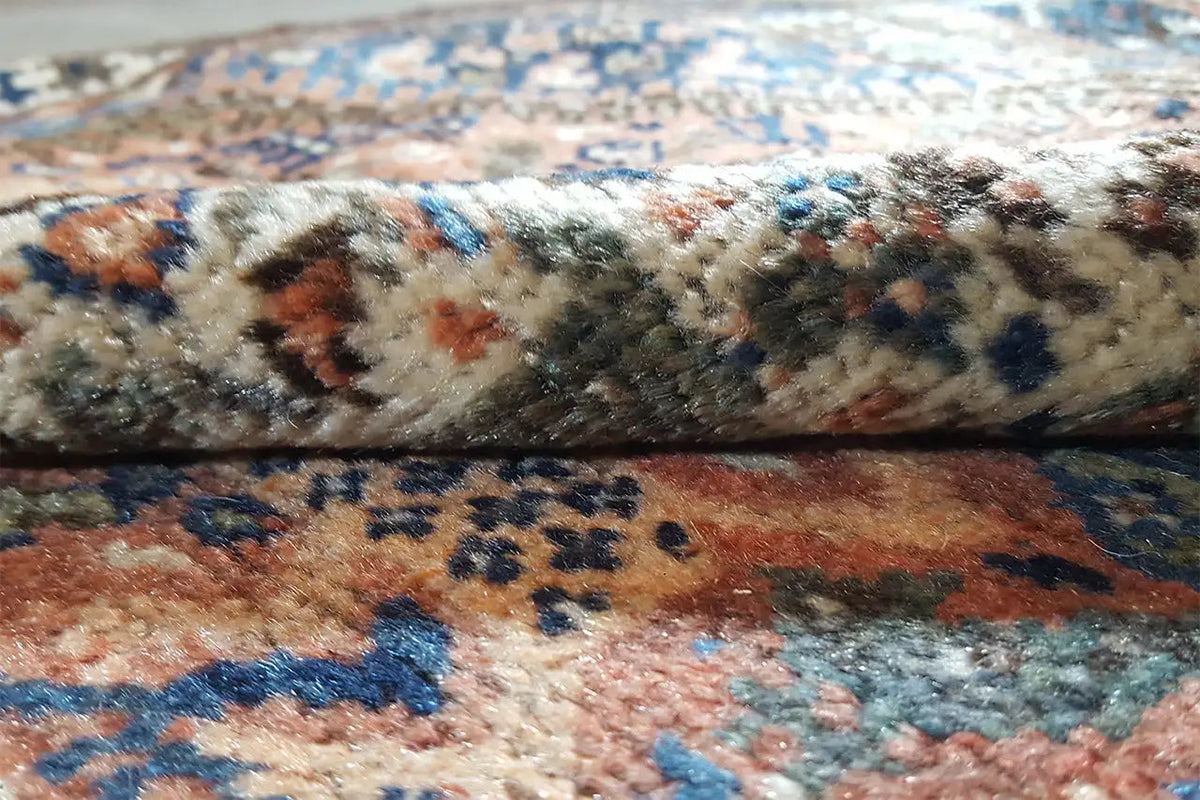 Carpet pile in detail, blue-brown patterns with colorful accents