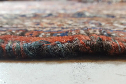 Rug edge with a dense pile texture and brownish-red tones