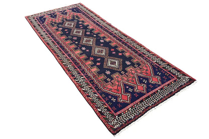 Sirjan runner: rectangular rug with a geometric border pattern in dark blue, red, and beige