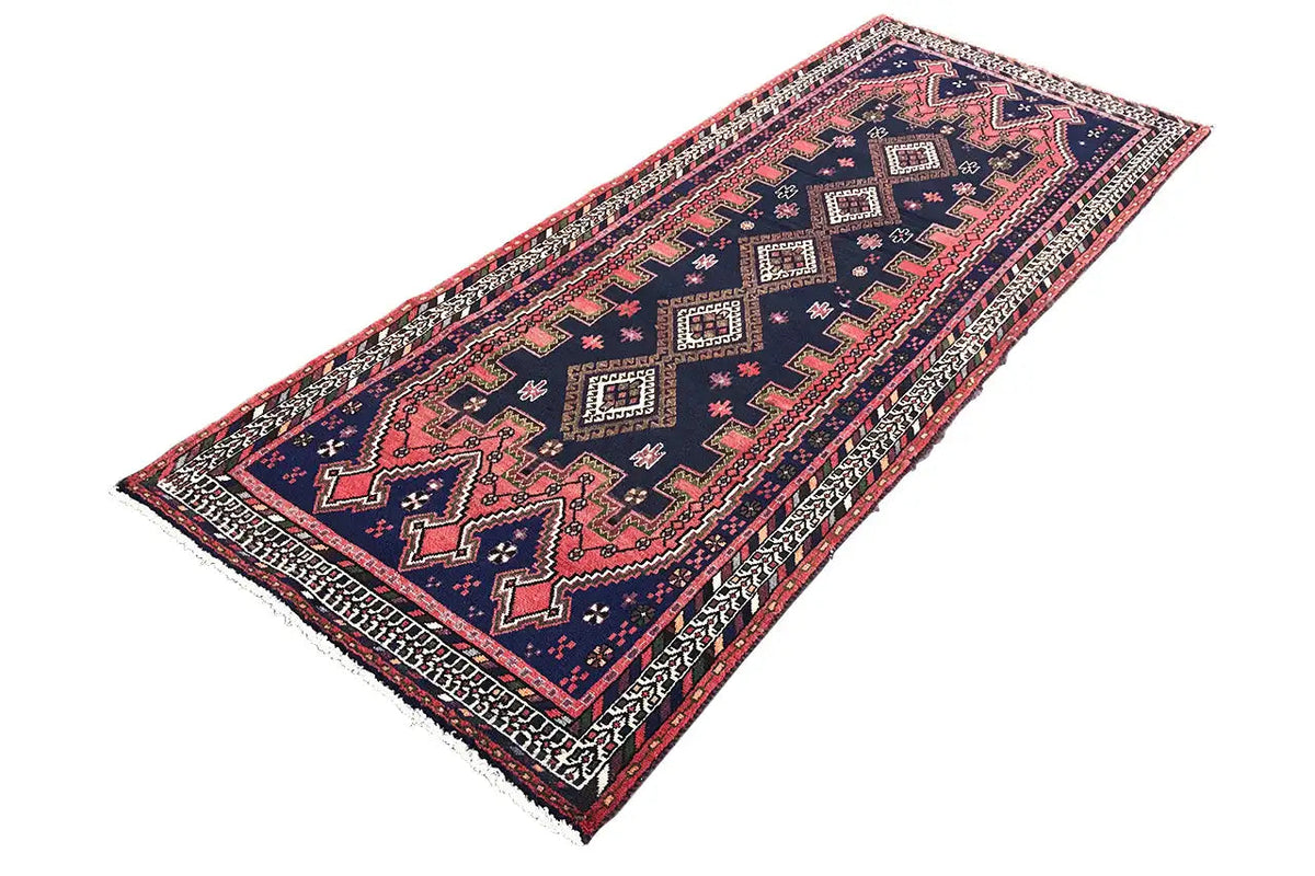 Sirjan runner laid out: dark blue carpet with red and beige ornaments and border