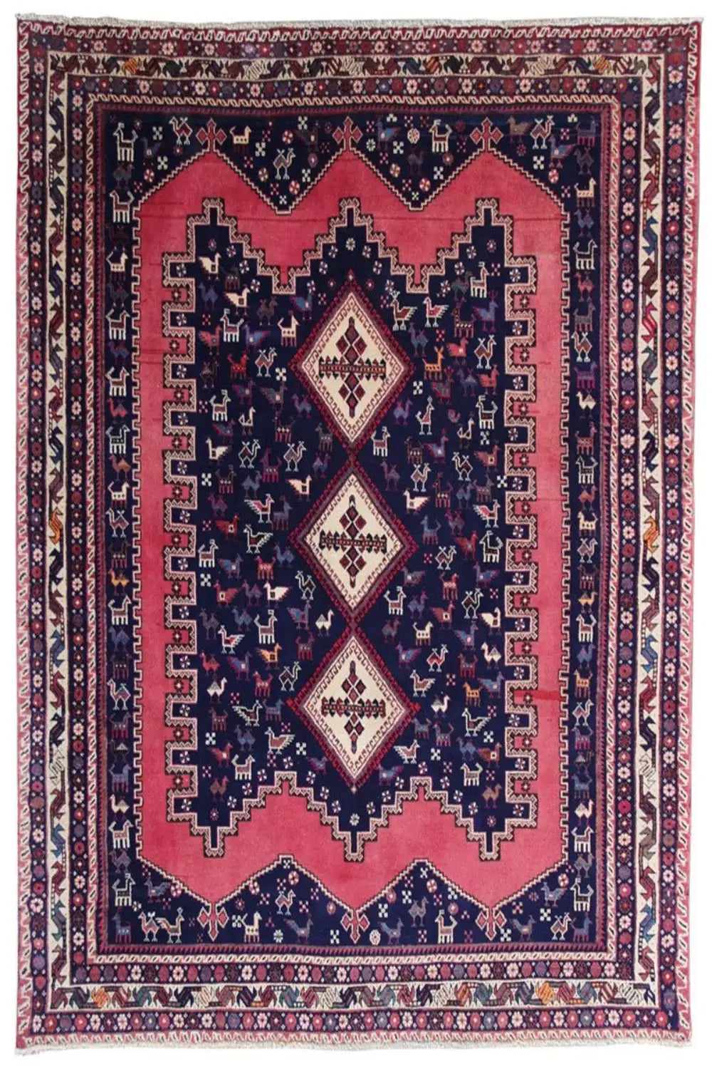 Oriental rug with a dark blue background, red medallion, and ornamental borders