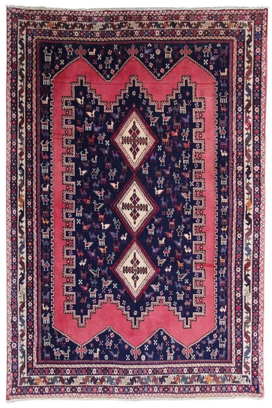 Oriental rug with a dark blue background, red medallion, and ornamental borders