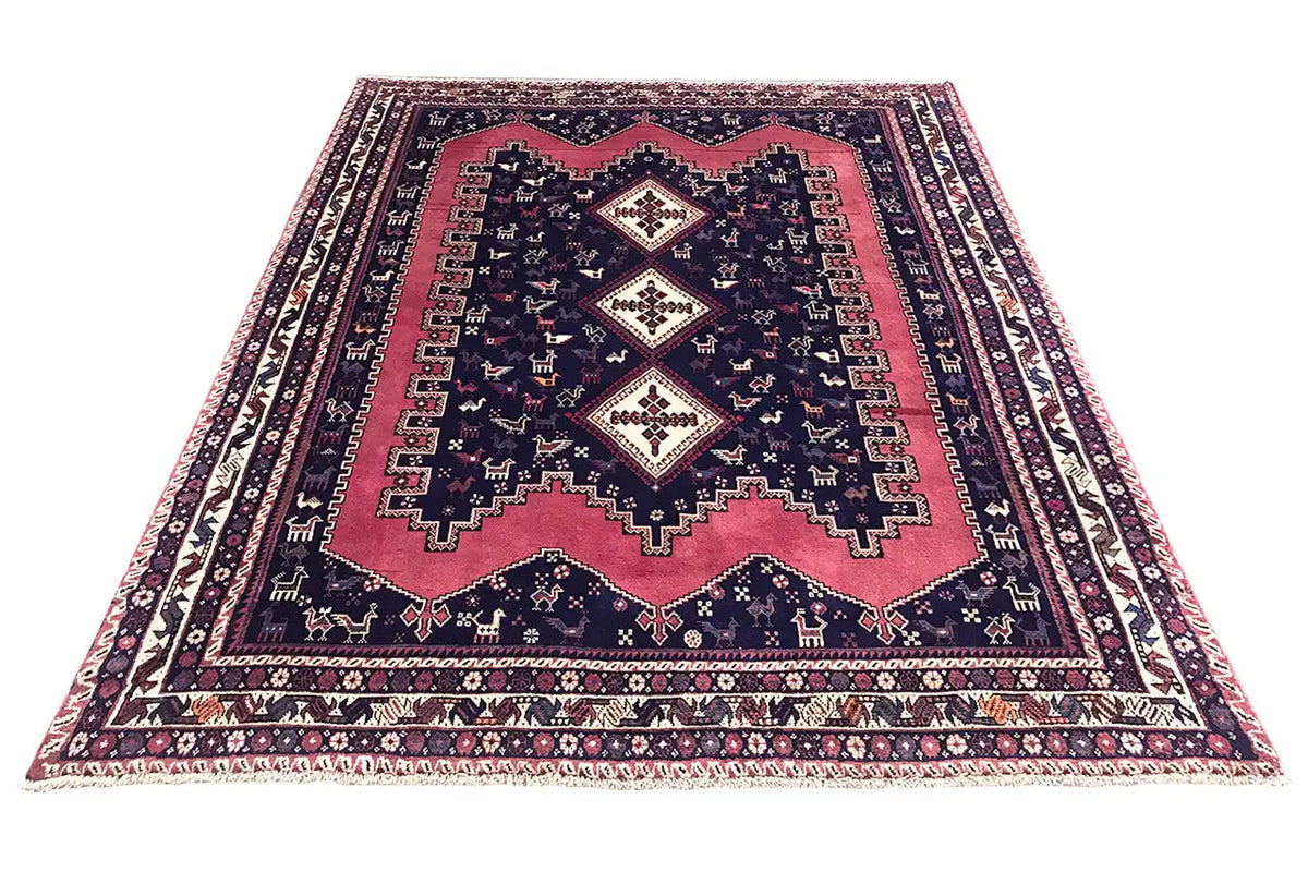 Oriental rug, spread out in a rectangle: dark blue with red areas and woven patterns