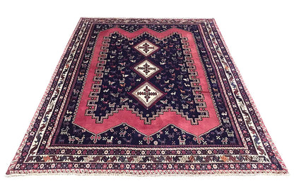 Oriental rug, spread out in a rectangle: dark blue with red areas and woven patterns