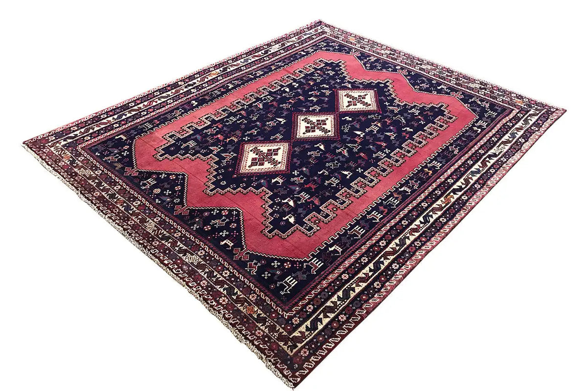 Oriental rug in a diagonal pattern: dark blue, red, and cream-colored tile motifs