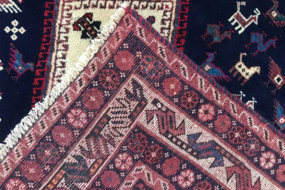 Oriental rug detail: woven texture with a lustrous thread, red and cream-colored patterns