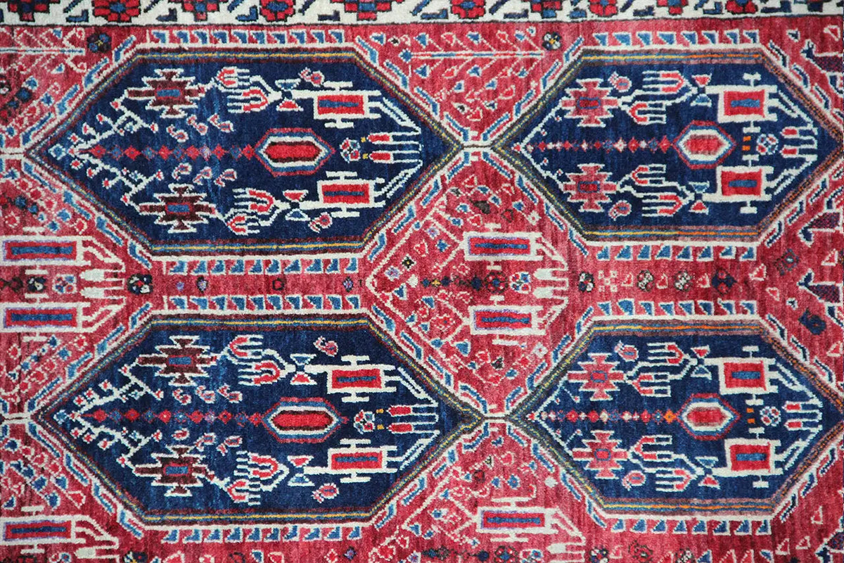 Close-up of the oriental rug with a blue and red hexagonal pattern