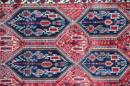 Close-up of the oriental rug with a blue and red hexagonal pattern