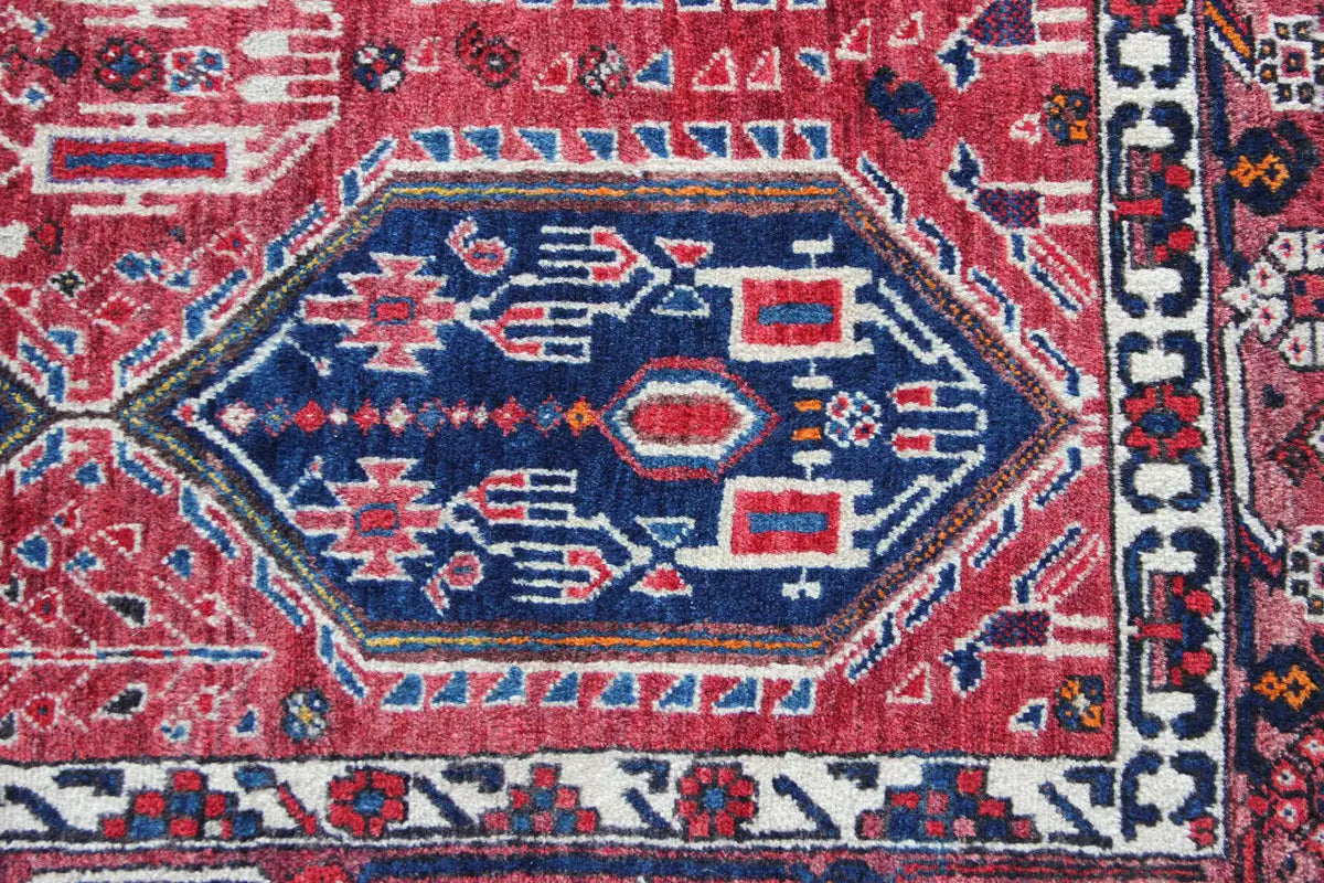 Oriental rug with a central blue octagon and red background