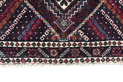 Close-up of the border with colorful patterns, fringed trim along the bottom edge