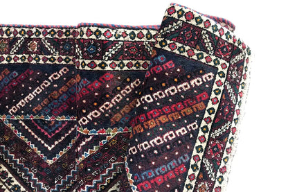 Bordered side of a runner with a continuous ornamental pattern, fringe along the edge