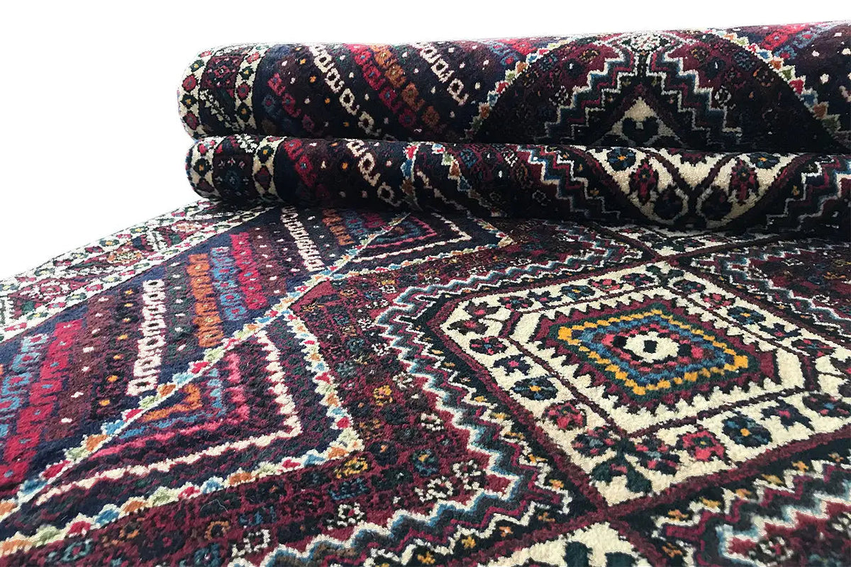 Sirjan runner with a geometric, multicolored pattern in dark blue, cream, and burgundy