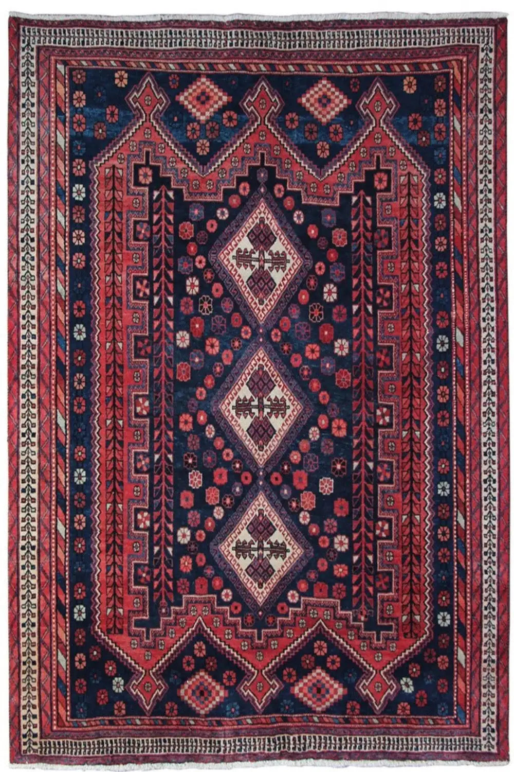 Rug with a dark blue background, red and white diamond medallions, and a surrounding border