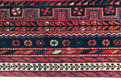 Carpet border with red and dark blue decorative bands and small patterned squares
