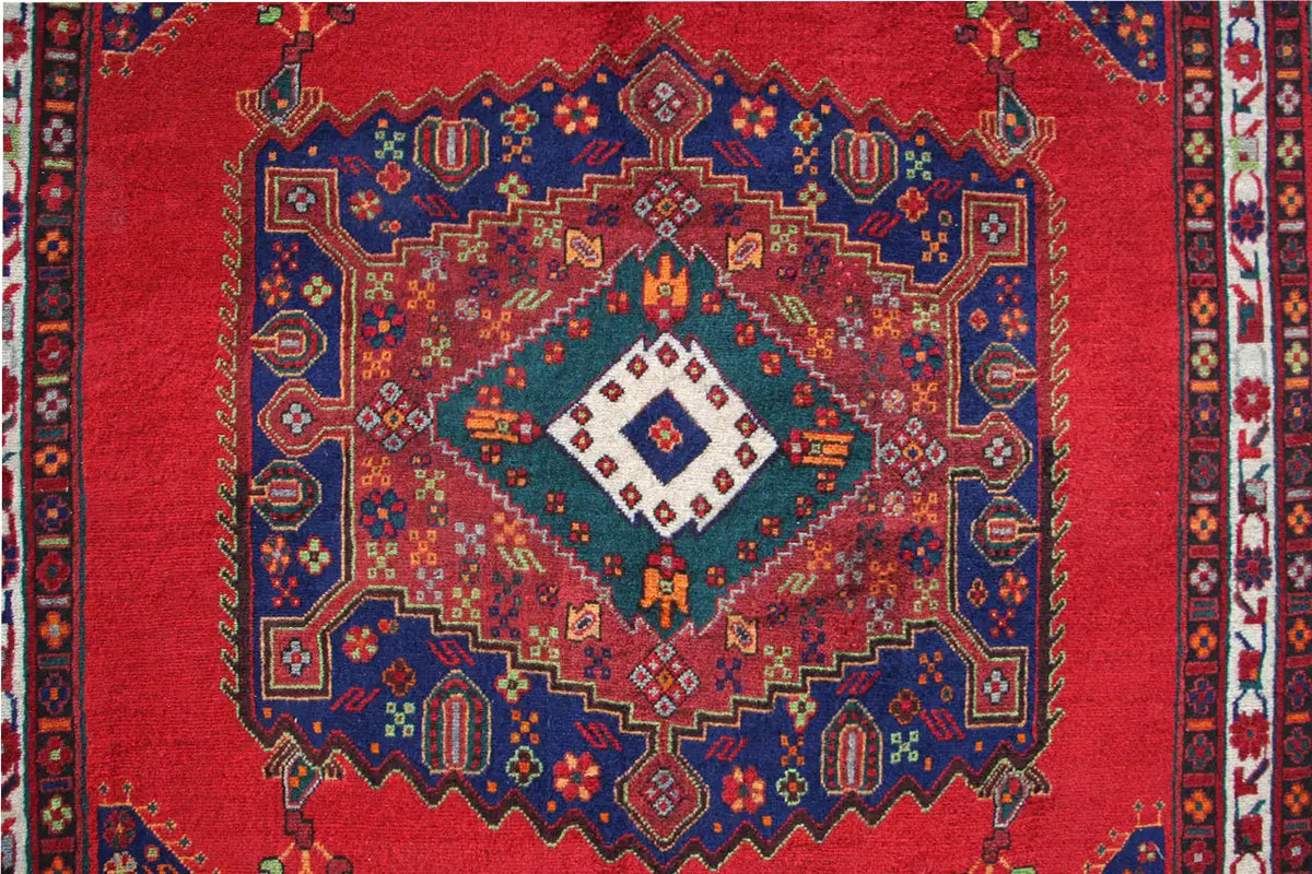 Carpet with a round medallion: red background, blue pattern, and multicolored ornaments