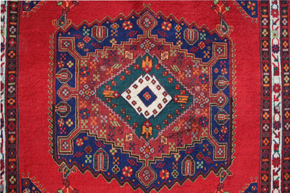 Carpet with a round medallion: red background, blue pattern, and multicolored ornaments