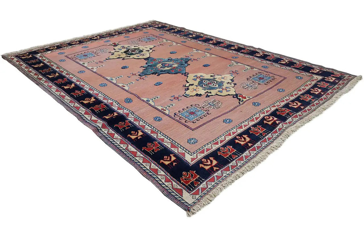 Oriental rug with a central medallion, blue pattern, and dark blue zigzag border