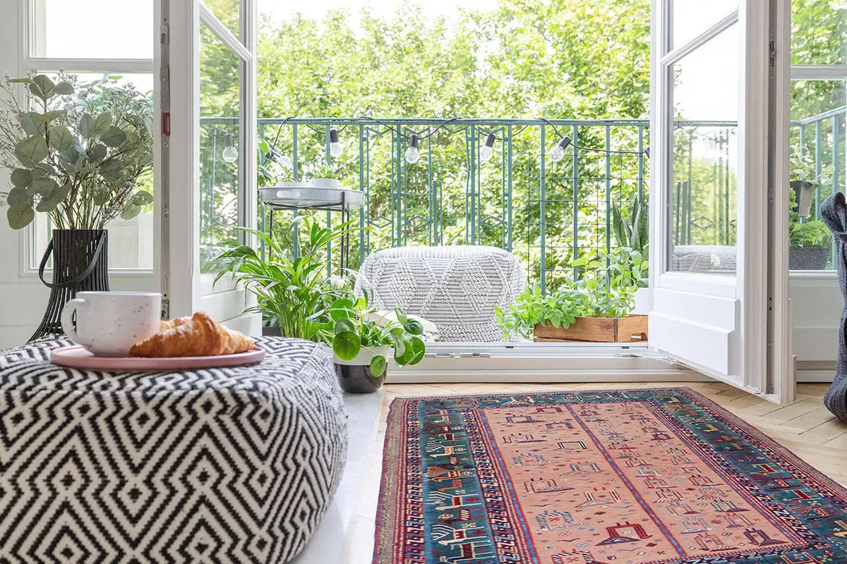 Oriental rug in the living area with a medallion pattern in blue, red, and pink