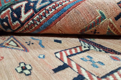Carpet detail with geometric patterns in pink, blue and dark green