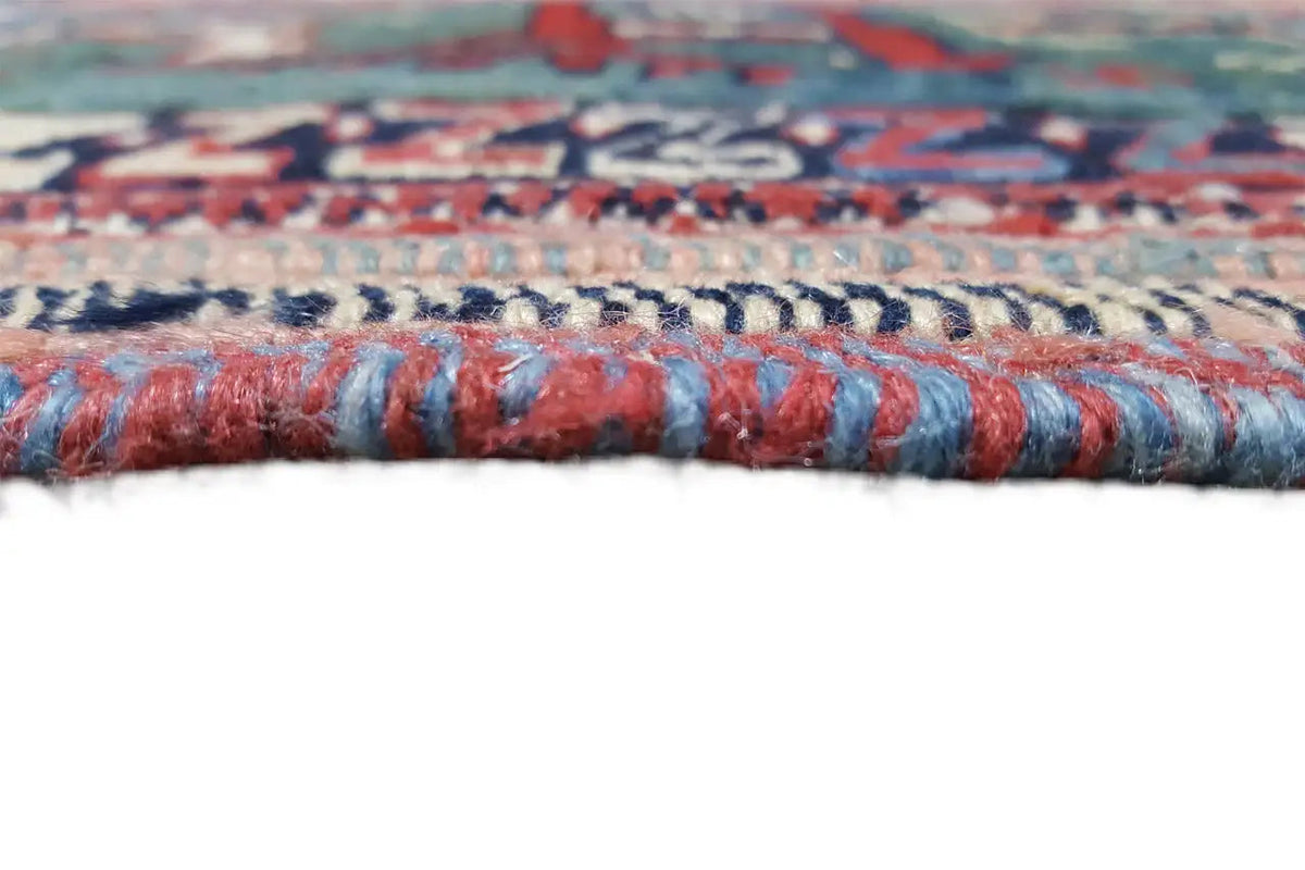 Carpet edge with multicolored fringes in blue, red, and beige