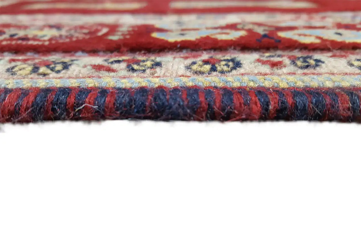 Carpet edge with a multicolored fringe finish in red, blue, and beige
