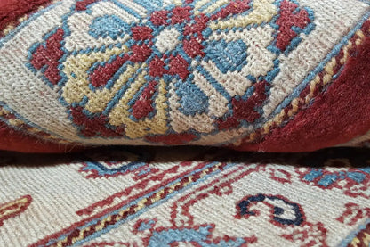 Carpet detail: woven-in floral patterns and ornaments in cream, blue, and red