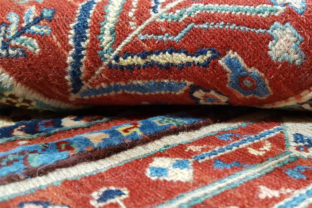 Carpet detail with red and blue ornamental stripes and decorative motifs