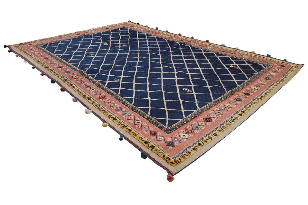 Rug with a dark blue diamond lattice and red borders, colorful tassels