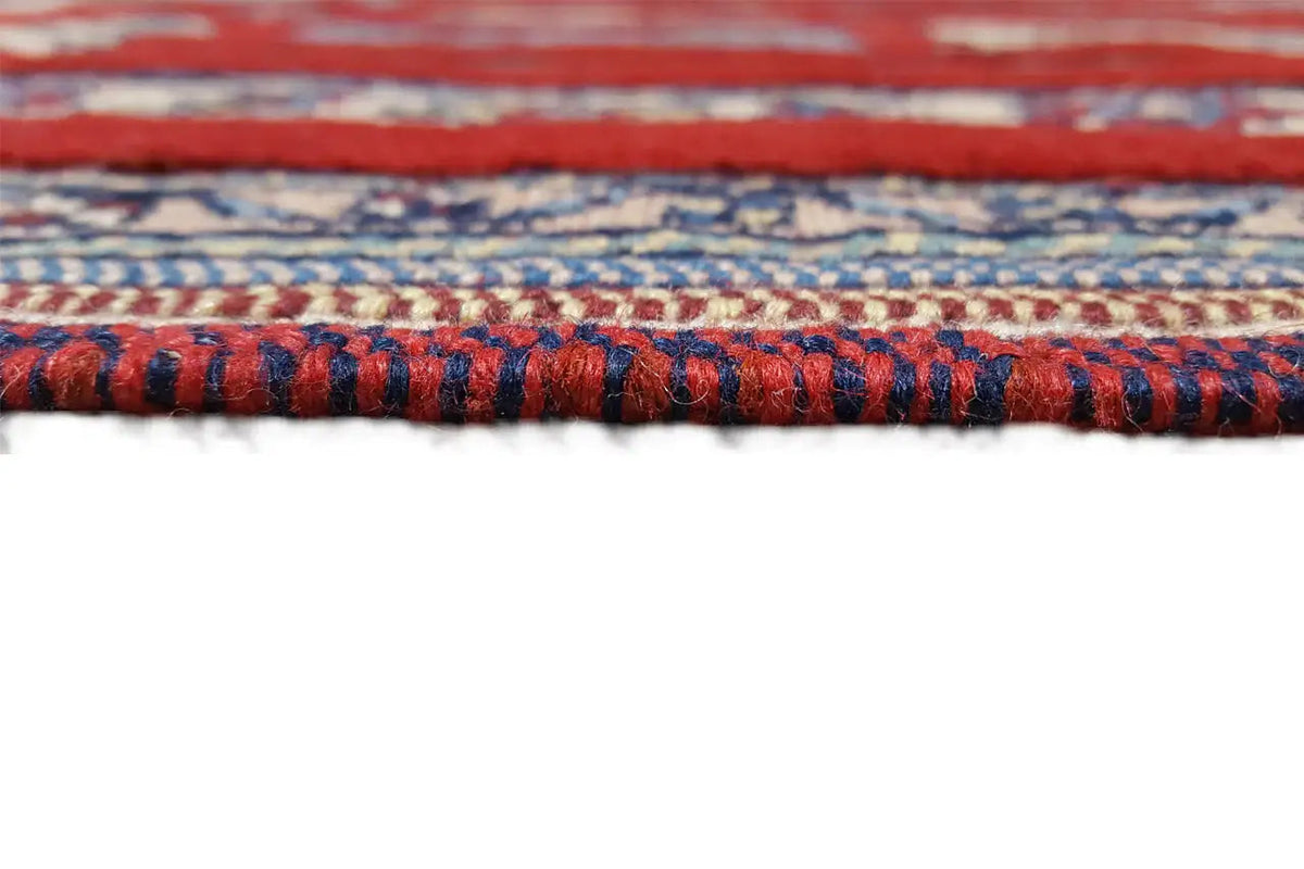Rug edge with fringe and a blue-and-red patterned border, fine embroidery