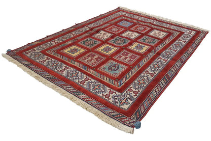 Oriental rug with a red pattern and multicolored borders, edges with fringes