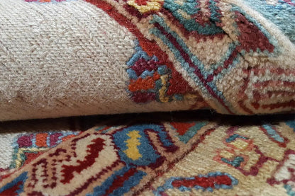 Soumak rug detail: beige pile with blue-red patterned stripes and embroidered motifs