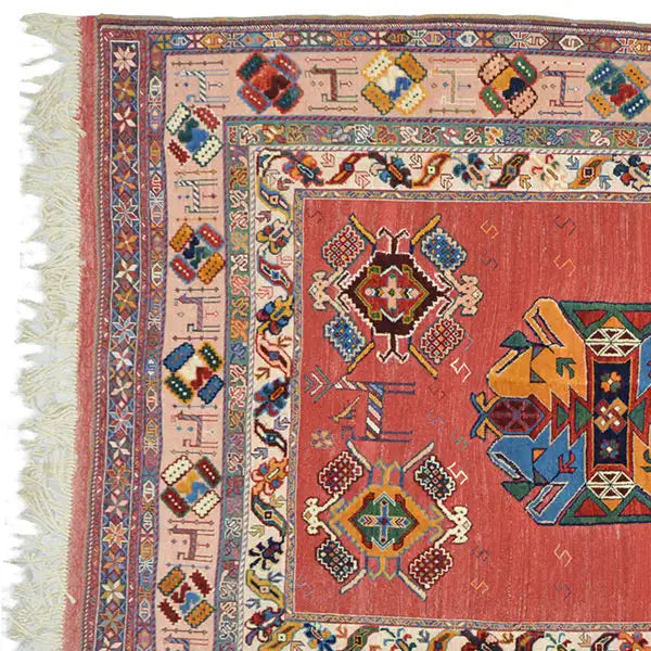 Soumak rug (200x145 cm) with a red central field, colorful borders, and fringes