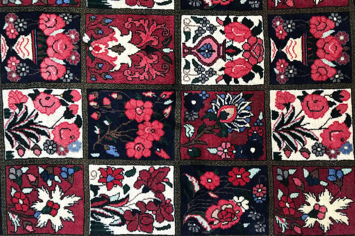 Oriental rug detail with colorful floral ornaments and vines in red, blue, and beige