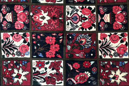 Oriental rug detail with colorful floral ornaments and vines in red, blue, and beige