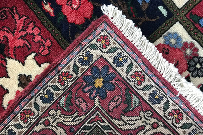 Oriental rug corner with fringed threads and a diamond pattern in red, blue, and beige
