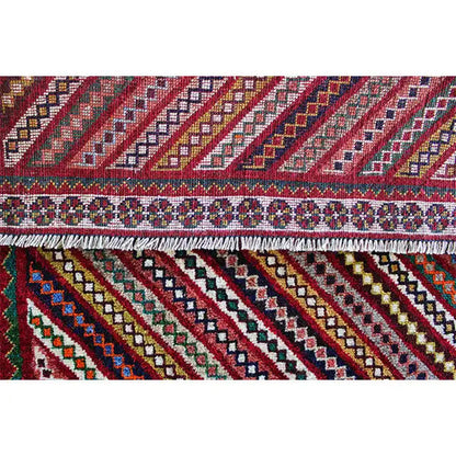 Gabbeh rug border detail: decorative trim with small ornaments and stripes underneath