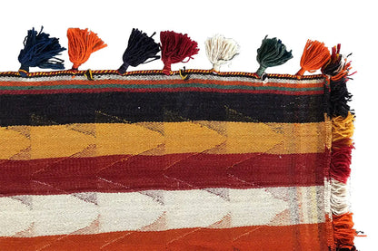 Jajim rug with a row of fringe along the edge and a striped color scheme