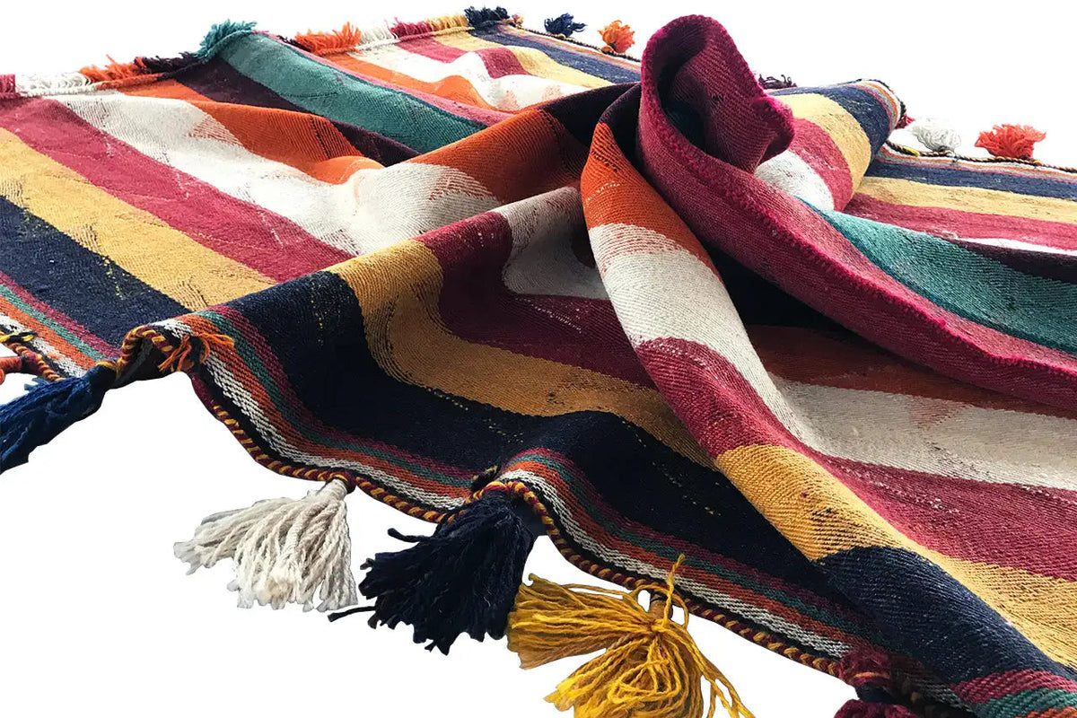 Jajim rug spread out: stripes in red, green, and blue with colorful fringes