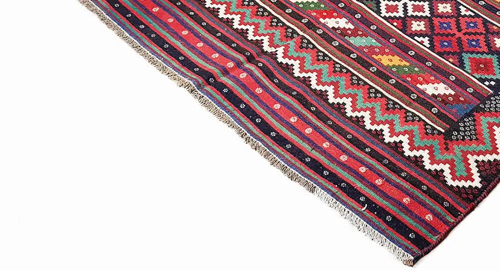 Kilim rug with geometric stripes in red, blue, green, and white patterns; with fringes.
