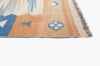 Kilim rug with fringes, a cream-colored background, and blue-orange geometric patterns