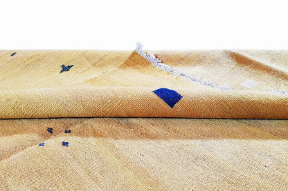 Ochre kilim rug with blue detail and fringes, woven fabric texture