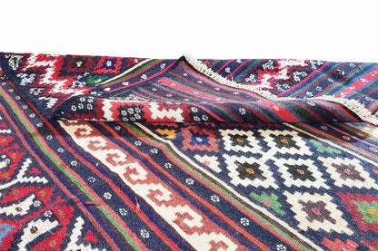 Close-up of a kilim rug with colorful stripes, small patterns, and a woven border