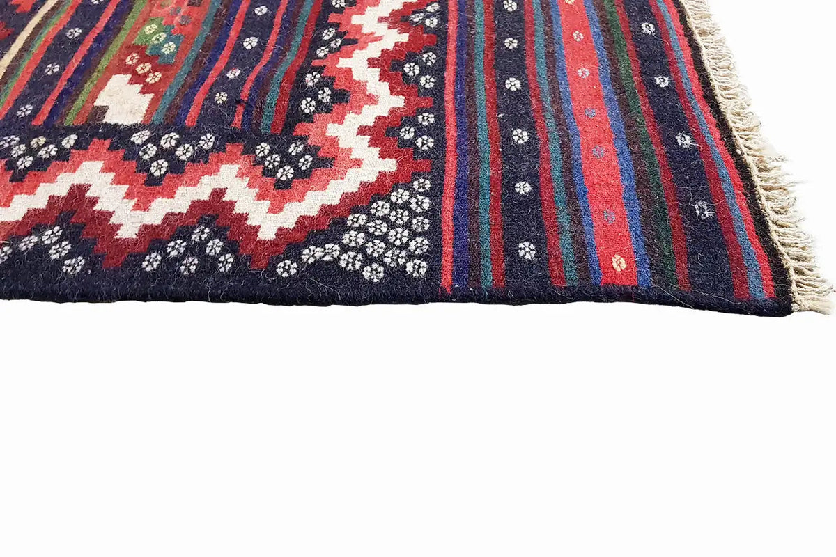 Kilim rug with fringe and vertical stripes, accent colors such as red, green, and blue