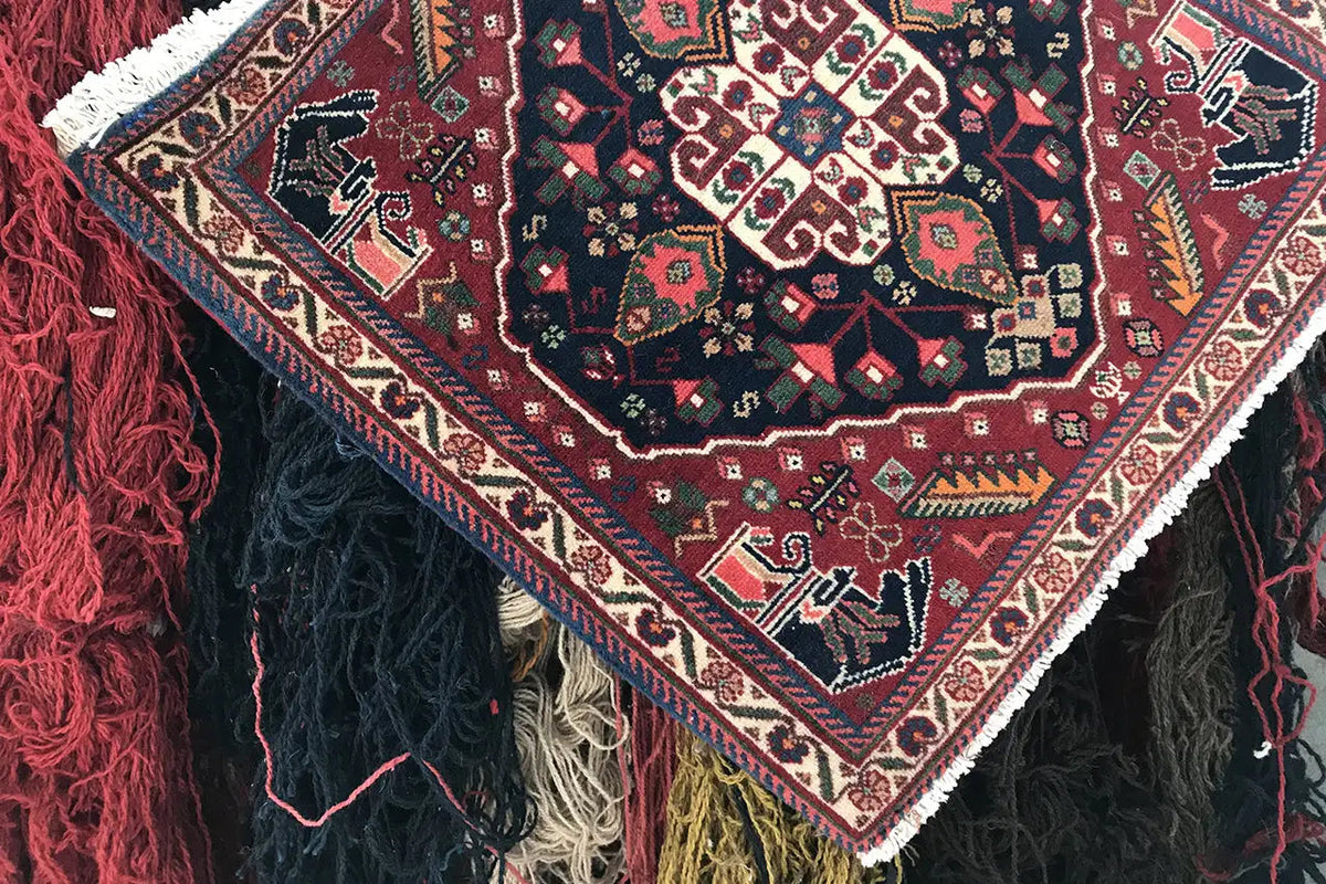 Rug with side fringes and a multicolored geometric pattern