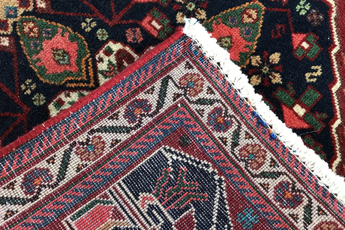 Close-up of the carpet edge: fine ornamentation in blue, red, green, and beige
