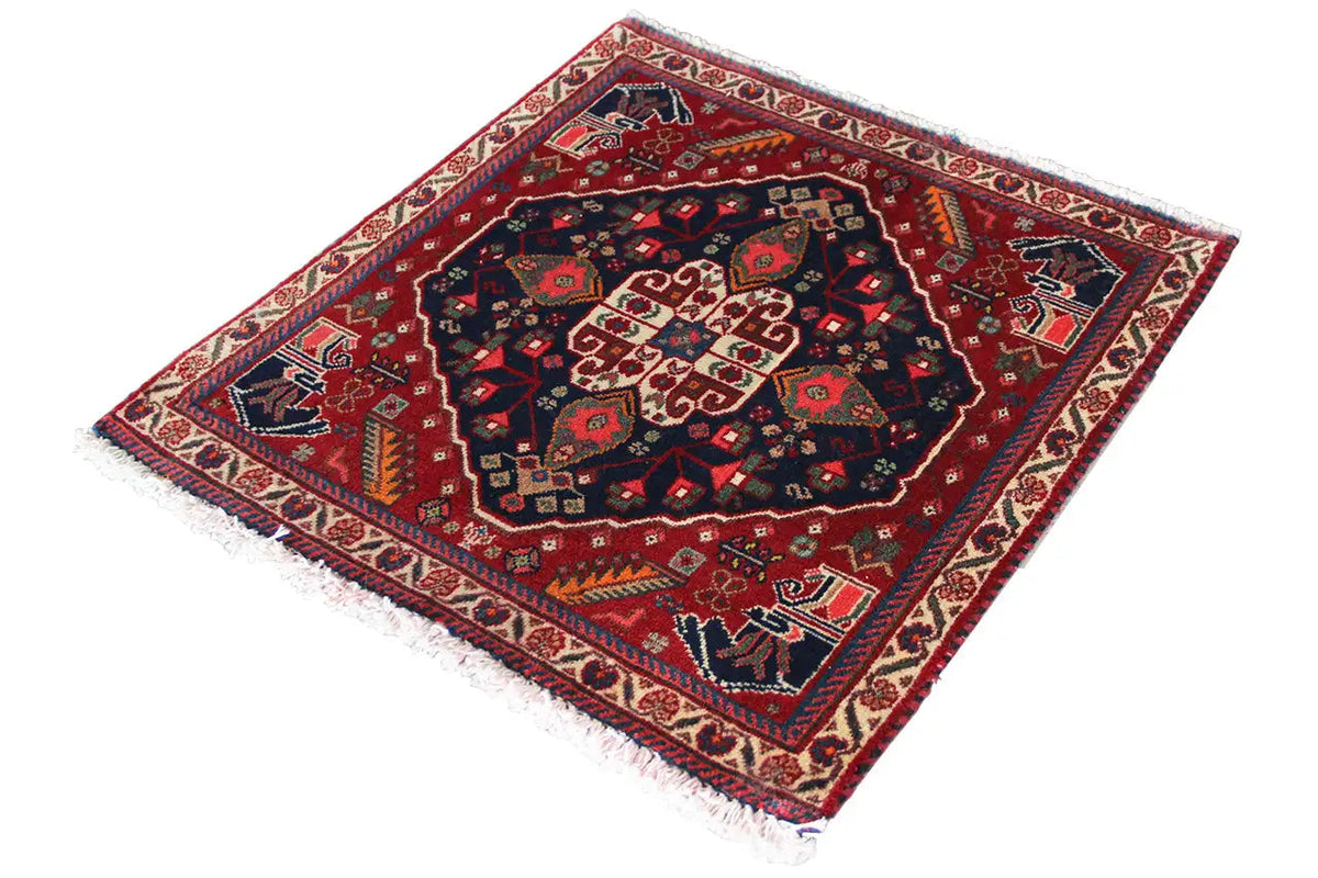 Qashqai rug by Poschti: rectangular, red border, dark blue pattern, surrounding fringe.